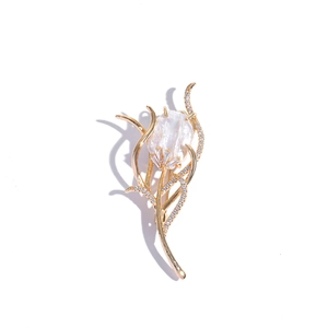 Close-up of tulip brooch with golden petals, micro-pave zircons and baroque pearl