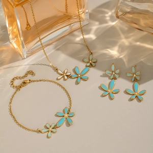 Golden 18K PVD plated jewelry set with blue and white enamel flowers and crystals