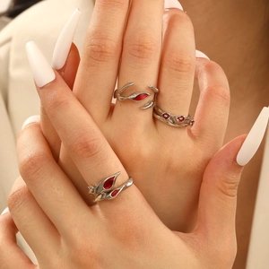 Detailed shot of Gothic punk adjustable rings with red stones on fingers