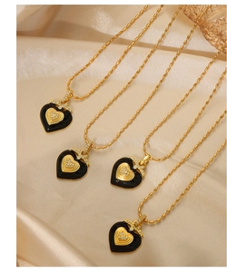 Detail of heart necklace with black enamel, gold heart inlay and micro-pave crystals