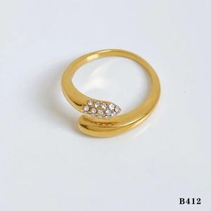 Macro shot of gold plated snake-shaped open ring with sparkling crystal inlay details