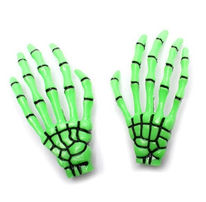 Macro detail of vibrant green skeleton hand hair clips with black bone accents in a pair