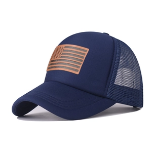 Detail of navy trucker hat with mesh back and leather American flag patch on front