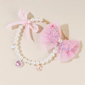 Detail of pearl pet collar with pink lace bow, heart and moon charms for cats and dogs