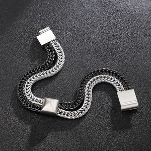 Detail of dual-tone silver and black woven dragon bone chain bracelet with metal clasp