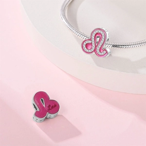 Macro shot of silver Leo charm with pink enamel and white zircon for DIY bracelets