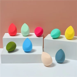 Macro shot of colorful beauty sponges in teardrop shapes on white podium displays