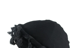 Close-up of black satin lined turban with fringe detail and soft textured fabric