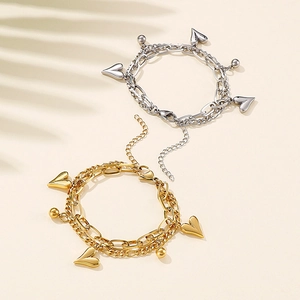 Double-layer heart charm bracelet in gold and silver finish with adjustable chain