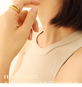 Macro detail of minimalist hollow C-shaped earrings with 18k gold plating on titanium steel