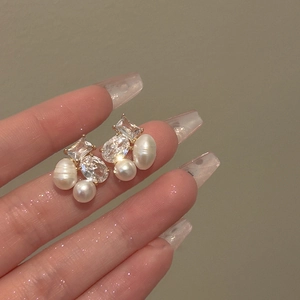 Elegant geometric gold earrings with baroque pearls and sparkling cubic zirconia crystals