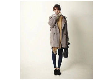 Brown herringbone double-breasted coat paired with a bright yellow scarf and casual boots