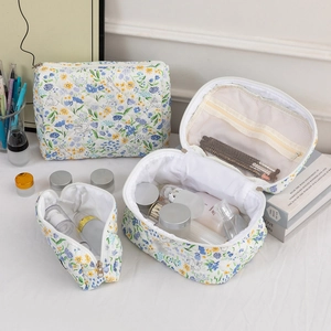 Three-piece quilted floral makeup bag set with internal compartments and brush slots