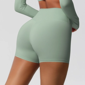 Detail view of sage green high-waisted yoga shorts with butt-lifting and tummy control fit