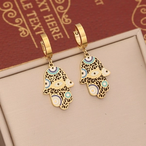 Gold Hamsa Hand earrings with Evil Eye enamel pattern and intricate hollow-out details