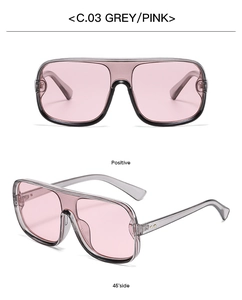 Macro detail of oversized grey resin frame sunglasses with translucent pink lenses