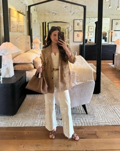 Detail of tan suede blazer with slim knit jumpsuit and leather accessories outfit