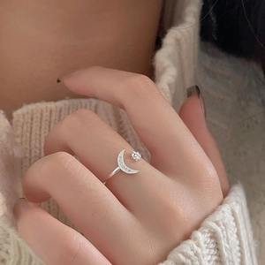 Macro detail of 925 sterling silver adjustable ring featuring moon and star zircon accents