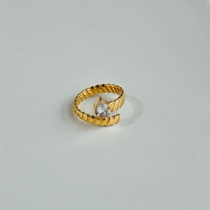 Macro view of 18k gold plated twist band ring featuring a pear cut zircon stone