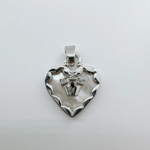 Detailed close-up of 18K gold heart pendant with natural mother of pearl shell and crown