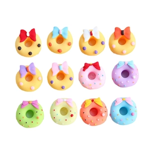 Colorful matte resin donut charms with bows for DIY crafts set on white background
