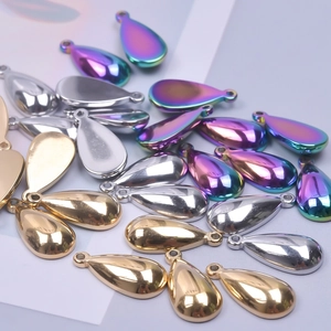 Macro view of teardrop metal pendants in gold, silver and rainbow finishes