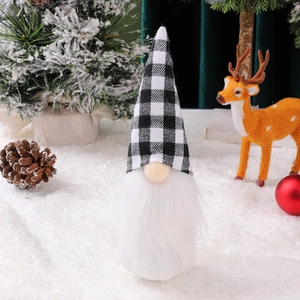 Close-up of black and white plaid Christmas gnome with plush beard and festive decor
