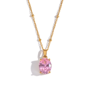 Macro view of a polished pink oval gemstone pendant with a four-claw gold setting
