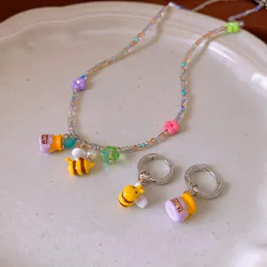 Beaded honey bee jewelry set with purple honey pot charm necklace and hoop earrings