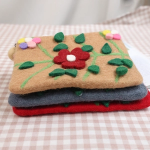 Handmade wool felt coin purse with embroidered floral vine patterns in three colors