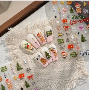 Detail of Christmas nail art stickers featuring bears, trees and snowflakes on a nude base