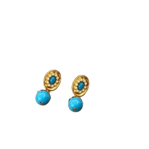 Golden earrings with blue oval gems, white pearl accents, and blue sphere drops