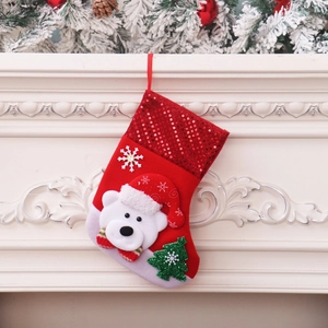 Detail of red felt Christmas stocking with 3D polar bear and sequined tree decoration