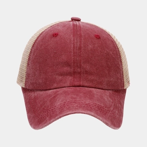 Detail of vintage washed cotton baseball cap showing mesh panels and distressed texture