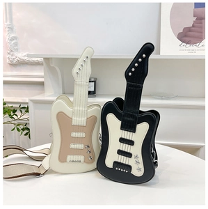 Detailed view of guitar-shaped crossbody bags with star studs and woven strap details