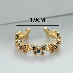 Detailed view of adjustable gold butterfly ring with blue crystal wings and 1.9cm diameter