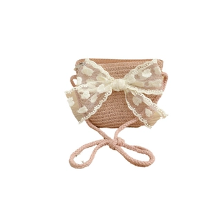Kids woven straw shoulder bag with a large white lace bow and polka dot embroidery