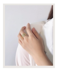 Detail view of gold wide ring with multi-layer winding texture and bark-like ripples