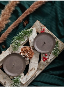 Close-up of Nordic double candle holder with birch bark, pine cones and red berries
