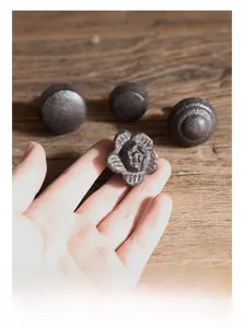 Detail of vintage cast iron drawer handles shown on weathered wood for furniture DIY
