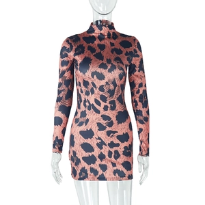 Detail of leopard print mini dress featuring a mock neck and slim fit long sleeves