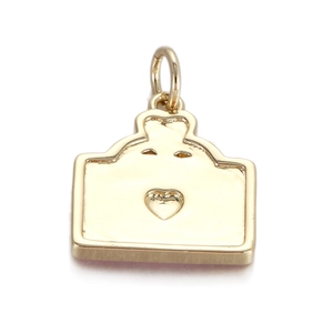 Macro detail of a gold heart embossed bread toast pendant with polished metallic finish