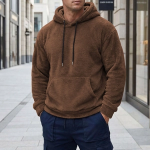 Close-up of fluffy brown sherpa fleece texture on a hooded men's street jacket