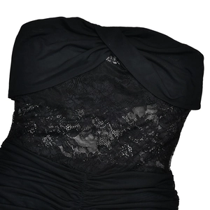 Detail of black mesh patchwork with lace insert and pleated texture on slim fit dress