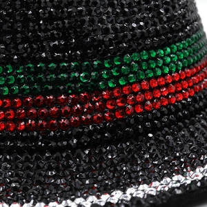 Macro detail of luxury jazz hat with hand-set black, green and red rhinestones