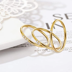 Close-up of three 18K gold-plated stacking rings with micro-inlaid cubic zirconia stones