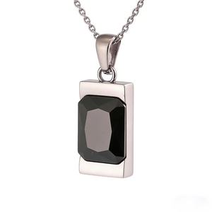 Detailed macro view of rectangular black gemstone set in a polished silver steel pendant