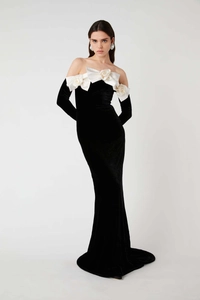 Detail of white 3D rose flowers and black velvet fabric on off-shoulder evening dress