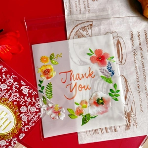 Detail of floral self-adhesive cookie bags with Thank You print in aesthetic setting