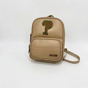 Khaki PU leather mini backpack featuring green tree towel embroidery and front pocket